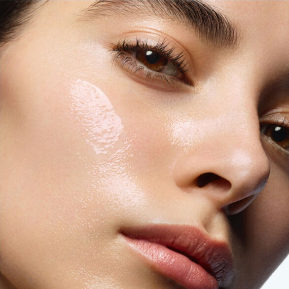 Closeup of model's face with dewy streak on cheek.