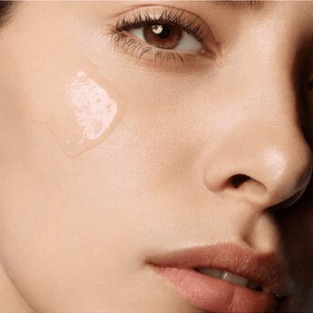 Closeup of model's face with smear of Pure Shots Lines Away Anti-Aging Serum on cheek