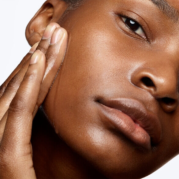 Woman rubbing Y Shape Serum onto the side of her face